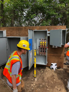 UPL Electrical team members installing an outdoor electrical box