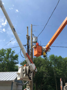 UPL Electrical team member in bucket performing pole line maintenance