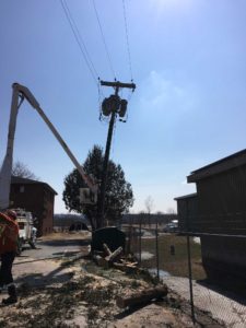 UPL Electrical team members installing a new electrical pole