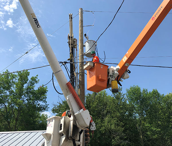 UPL Electrical team member in bucket performing pole line maintenance